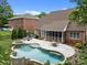 Expansive backyard features pool, spa, patio with furniture, and lush landscaping at 310 E Waterlynn Rd, Mooresville, NC 28115