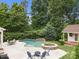 Backyard displaying a pool, spa, shed, patio, surrounding greenery, and seating area at 310 E Waterlynn Rd, Mooresville, NC 28115
