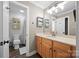 Well-lit bathroom showcasing a single sink vanity, wall shelves, and a separate toilet and shower area at 310 E Waterlynn Rd, Mooresville, NC 28115