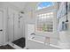 Bright bathroom highlighting a soaking tub beneath an arched window and a separate glass shower at 310 E Waterlynn Rd, Mooresville, NC 28115