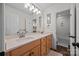 Bright bathroom featuring double sinks, a large mirror, and an adjacent shower and toilet room at 310 E Waterlynn Rd, Mooresville, NC 28115