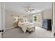Bedroom with a ceiling fan, carpeted floors, natural light, and a small decorative desk at 310 E Waterlynn Rd, Mooresville, NC 28115