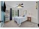 Bedroom with a ceiling fan, hardwood floors, a TV, and natural light coming through a window at 310 E Waterlynn Rd, Mooresville, NC 28115