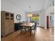 Elegant dining room features hardwood floors, wainscoting, and a large window for natural light at 310 E Waterlynn Rd, Mooresville, NC 28115