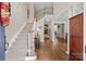 Grand foyer features hardwood floors, a staircase, and a view into the formal living room at 310 E Waterlynn Rd, Mooresville, NC 28115
