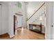 Bright foyer features hardwood floors, a staircase, and a view of the front door at 310 E Waterlynn Rd, Mooresville, NC 28115