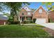 Charming two-story brick home with a manicured lawn and inviting front porch, perfect for relaxing evenings at 310 E Waterlynn Rd, Mooresville, NC 28115