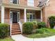 Inviting front porch with brick steps, classic columns, and a cozy seating area perfect for relaxation at 310 E Waterlynn Rd, Mooresville, NC 28115