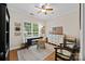 Well-lit home office featuring hardwood floors, natural light, and ample shelving and storage at 310 E Waterlynn Rd, Mooresville, NC 28115