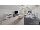 Spacious upstairs living room featuring a large sectional sofa, TV, and natural light at 310 E Waterlynn Rd, Mooresville, NC 28115