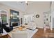 Open-concept living room with a fireplace, hardwood floors, and neutral decor at 310 E Waterlynn Rd, Mooresville, NC 28115