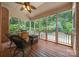 Screened porch boasts wooded backyard, with grill, furniture and view of the pool at 310 E Waterlynn Rd, Mooresville, NC 28115