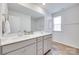Well-lit bathroom featuring a double vanity, large mirror, and wood-look floors at 3101 Virginia Trail Ct, Fort Mill, SC 29715