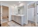 Bathroom featuring double sinks, grey cabinets, and wood-look floors at 3101 Virginia Trail Ct, Fort Mill, SC 29715