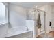Bright bathroom featuring a large tub, glass shower, and stylish fixtures at 3101 Virginia Trail Ct, Fort Mill, SC 29715