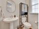 Charming half-bathroom features a pedestal sink, stylish fixtures, and natural light at 3101 Virginia Trail Ct, Fort Mill, SC 29715