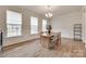 Elegant dining room featuring hardwood floors, a chandelier, and large windows at 3101 Virginia Trail Ct, Fort Mill, SC 29715
