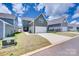 View of a modern house with a two-car garage and a well-maintained lawn on a sunny day at 3101 Virginia Trail Ct, Fort Mill, SC 29715