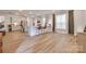 Open-concept living space with kitchen with bar seating, leading into living room with modern decor and natural light at 3101 Virginia Trail Ct, Fort Mill, SC 29715