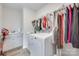 Bright laundry room featuring washer, dryer, cabinets, and a clothing rod for hang-drying garments in a home at 3101 Virginia Trail Ct, Fort Mill, SC 29715
