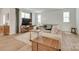 Inviting living room with a large sectional sofa, wood accents, and ample natural light at 3101 Virginia Trail Ct, Fort Mill, SC 29715