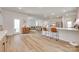 Open-concept living space with bar seating, leading into living room with modern decor and natural light at 3101 Virginia Trail Ct, Fort Mill, SC 29715