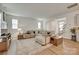 Comfortable living room with large sectional sofa, wood floors, and plenty of natural light at 3101 Virginia Trail Ct, Fort Mill, SC 29715