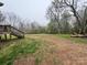 A spacious backyard with lush grass and mature trees and wooden stairs at 3103 Blue Ridge Dr, Shelby, NC 28150