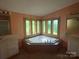 Bathroom featuring a large tub with natural light and dual vanities at 3103 Blue Ridge Dr, Shelby, NC 28150