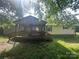 Exterior showcasing a welcoming porch framed by lush greenery and a canopy of trees at 3103 Blue Ridge Dr, Shelby, NC 28150