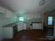 Functional kitchen with white cabinetry, wood floors, and a corner sink overlooking the yard at 3103 Blue Ridge Dr, Shelby, NC 28150