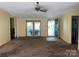 Bright living room with a ceiling fan, leading to an inviting outdoor area through glass doors at 3103 Blue Ridge Dr, Shelby, NC 28150