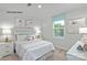 A cheerful bedroom featuring a bed, side tables with lamps, natural light, and colorful decor at 336 Maplestead St # 1080, Lancaster, SC 29720