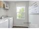 A laundry room featuring a white washer and dryer, wire shelves, and luxury vinyl plank flooring at 336 Maplestead St # 1080, Lancaster, SC 29720