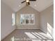 Spacious bedroom with a vaulted ceiling, carpet flooring, and a large window overlooking the trees at 3439 Stags Leap Way, York, SC 29745
