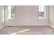 Bright bedroom featuring carpet flooring, shiplap accent wall, and natural light from two windows at 3439 Stags Leap Way, York, SC 29745
