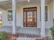 Elegant front door with sidelights and transom windows, framed by white columns on a covered porch at 3439 Stags Leap Way, York, SC 29745