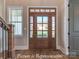Beautiful wood front door with glass panels and sidelights, complemented by hardwood floors at 3439 Stags Leap Way, York, SC 29745