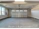 Spacious two car garage with concrete floors and white paneled garage door at 3439 Stags Leap Way, York, SC 29745
