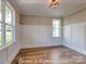 Cozy living room with hardwood floors, wainscoting, and natural light from the windows at 3439 Stags Leap Way, York, SC 29745