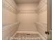An open walk-in closet includes wall-to-wall white shelving, with a carpeted floor at 3439 Stags Leap Way, York, SC 29745