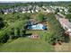 Aerial view of community playground and pool with blue umbrellas and mature trees at 3446 Broadwick St, Charlotte, NC 28213