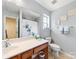 Bright full bathroom with modern vanity, framed mirror, and tub with shower at 3446 Broadwick St, Charlotte, NC 28213
