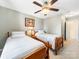 Comfortable bedroom features twin beds, ceiling fan, neutral paint and warm lighting at 3446 Broadwick St, Charlotte, NC 28213