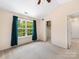 Bright bedroom with large window, natural light, walk-in closet, and neutral carpet at 3446 Broadwick St, Charlotte, NC 28213