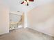 Large bedroom with a ceiling fan, neutral paint and carpet, with open railing to below at 3446 Broadwick St, Charlotte, NC 28213