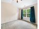 Bright carpeted bedroom with a vaulted ceiling and large window with green views at 3446 Broadwick St, Charlotte, NC 28213