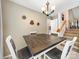 Dining room featuring neutral walls, chandelier lighting, and staircase view at 3446 Broadwick St, Charlotte, NC 28213
