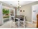 Cozy dining room has sliding doors to the backyard patio, neutral walls, and chandelier lighting at 3446 Broadwick St, Charlotte, NC 28213
