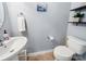 Simple half-bathroom showcasing a pedestal sink, toilet, and wall decor at 3446 Broadwick St, Charlotte, NC 28213